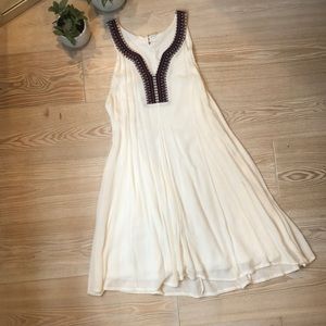 White swing dress w embroidered detailed neckline